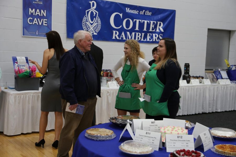 Chronicle members helping Mr. Horton bid on some sweets.